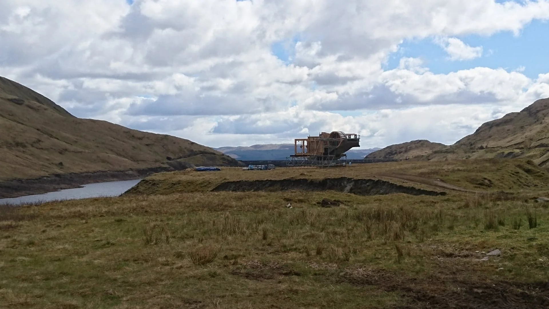 Vue éloignée du chantier du vaisseau d’Andor au milieu de la vallée écossaise