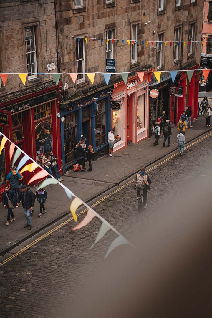 Commerces et passants dans Victoria Street au cœur d’Édimbourg